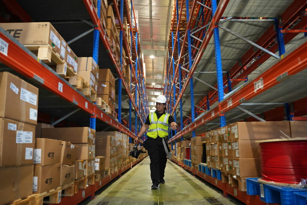 Staff is partoling around warehouse rack