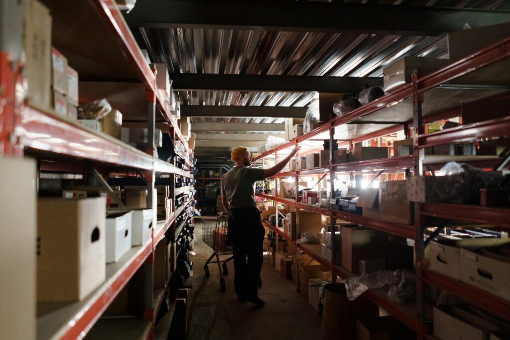 staff is picking item from warehouse storage rack