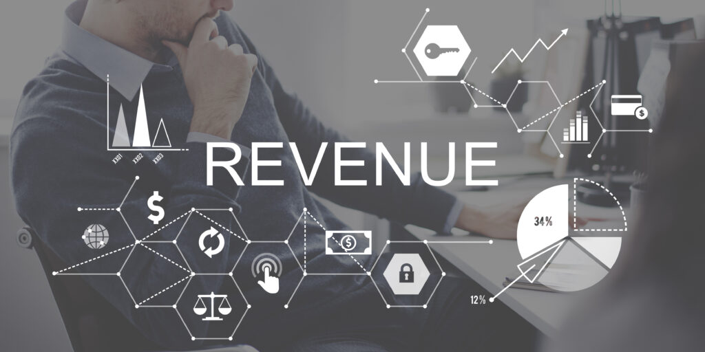 Business professional analyzing revenue data with financial charts, graphs, and digital icons representing growth and financial performance.