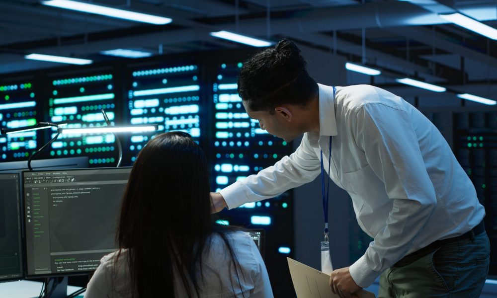Administrator monitoring dashboards with performance metrics and alerts, managing and maintaining enterprise software operations in real time.